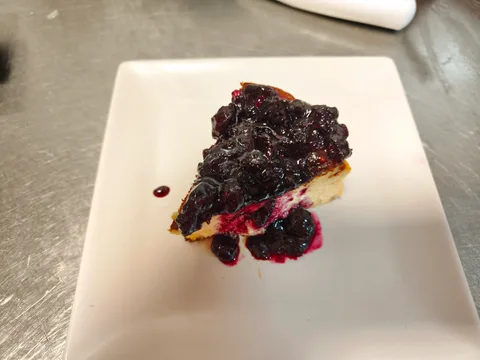 Tarta de queso casera con mermelada de arándanos.